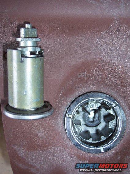 close-up of a car door lock cylinder and its internal mechanism