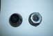 1983 Ford Bronco - Two wheel lug nuts are shown on a piece of lined paper, one appears to be black and the other silver.
