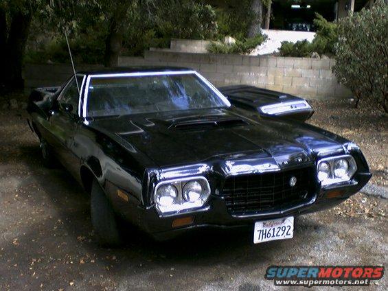 Black 1972 Ford Ranchero with a hood scoop and chrome grille, parked outdoors