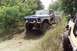 1979 Ford Bronco - A modified Ford truck navigates a grassy incline with another vehicle visible to the right.