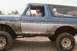 1979 Ford Bronco - Muddy 1979 Ford Bronco seen off-road with driver behind the wheel.