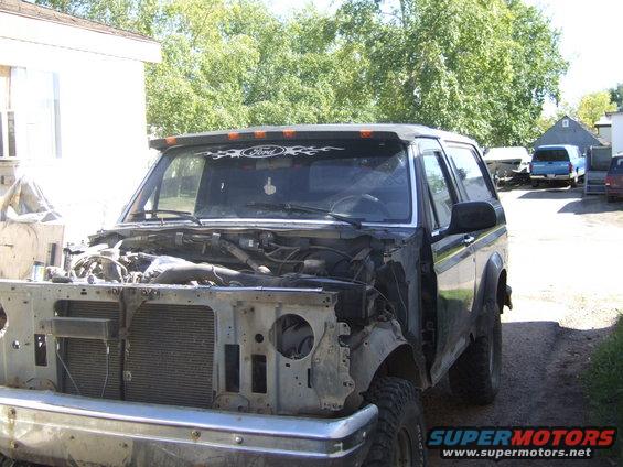 1989 Ford Bronco, front end disassembled, parked outside