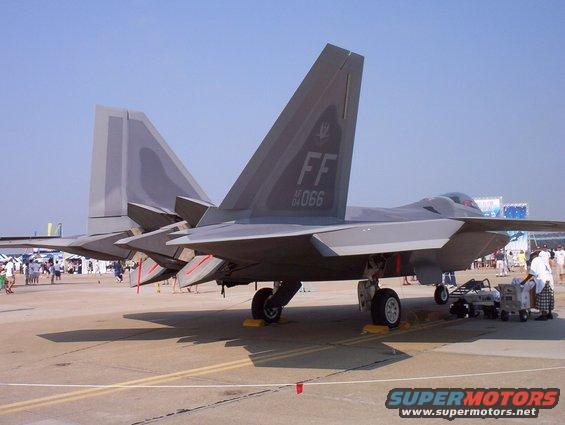 Rear view of two F-22 Raptor fighter jets on tarmac, with 'FF 066' visible on one