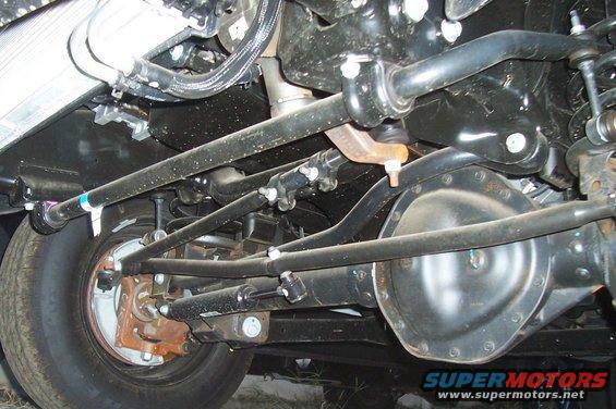 Underside view of front axle, steering linkage, sway bar, and suspension components