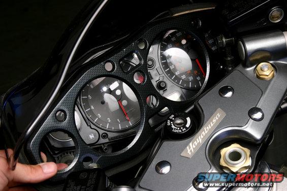 busa6.jpg Since the bezel is still attached by the double-sided tape, you will have to pry it up carefully to avoid damaging the gauge cluster. We were able to get the job done with a flat screwdriver and our fingers working from the left side towards the right.