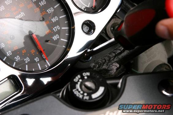 busa8.jpg To permanently mount the bezel, peel the cover-strips off the double-sided tape on the back of the PPM Custom bezel.  The tape will instantly adhere once it touches the gauge cluster, so it’s important to get the position right the first time.  Our bezel fit so well that it really wasn’t a problem getting it lined up perfectly.  Once it’s pressed into place with the tape, install and tighten the Phillips screws along the bottom edge to pull the bezel flat against the cluster.