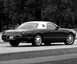 2002 Ford Thunderbird - Black 2002 Ford Thunderbird with a removable white hardtop is parked on a road.
