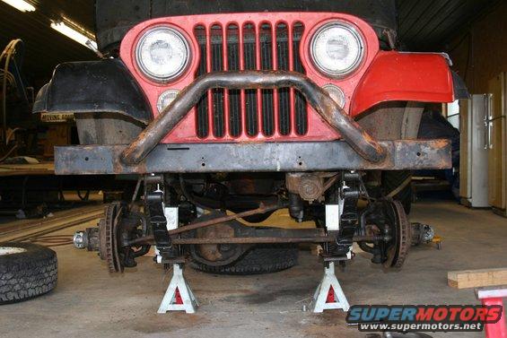 1979 Jeep CJ5 front end with custom bumper and grille, raised on jack stands for maintenance