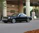 2002 Ford Thunderbird - A black 2002 Ford Thunderbird convertible with a white hardtop is parked outside a building with a Neiman Marcus sign.