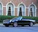 2002 Ford Thunderbird - This black 2002 Ford Thunderbird convertible is shown from a three-quarter front view, parked in front of a brick building with arched wind…
