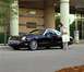 2002 Ford Thunderbird - A woman approaches a black 2002 Ford Thunderbird parked outside a building with a Neiman Marcus sign.
