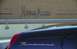 2002 Ford Thunderbird - A dark blue 2002 Ford Thunderbird is seen from the rear, with the 'Neiman Marcus' logo visible on a building in the background.