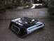 1972 Ford Ranchero - A black truck bed cap sits on the ground in front of a cinder block wall.