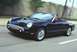 2002 Ford Thunderbird - A black 2002 Ford Thunderbird convertible is shown driving on a highway.