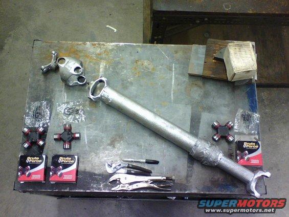 here is the driveshaft all disassembled with the new  parts ready to be put in.   The part numbers for the dual u-joint end of the drive shaft are 2-4800BF and from the single u-joint end it is 2-4900BF both from auto zone.  The main difference I saw between the 4800 and 4900 is the 4800 has all endcaps the same size O.D. and on the 4900 one axis endcaps are bigger than the others.