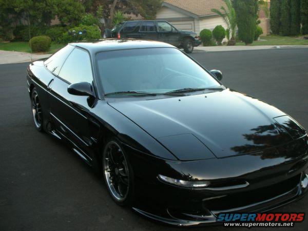 Black 1994 Ford Probe parked on asphalt driveway