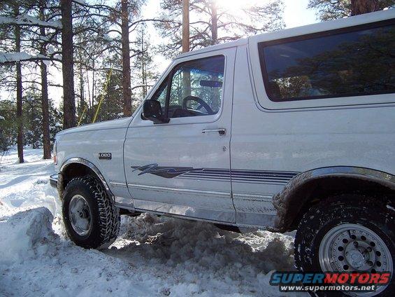 White 1996 Ford Bronco side view in snowy woods