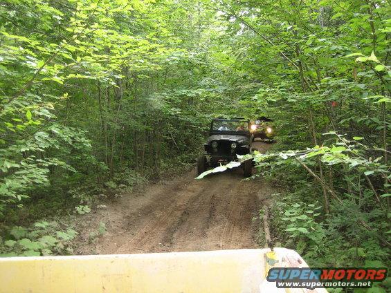 Off-road vehicles on a dirt path in a forest