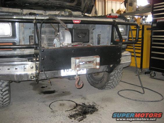 1986 Ford Bronco front end with winch and brush guard, parked in a garage