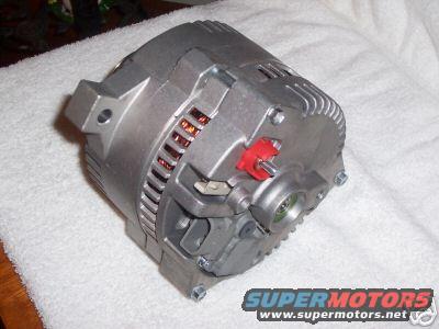 Silver alternator with red plastic clip, on a white towel