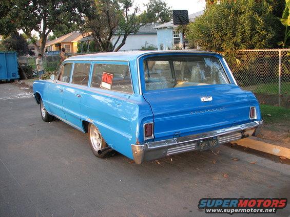 Blue 1963 Chevrolet station wagon rear view with 'For Sale' sign in window
