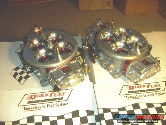 Two Quick Fuel Technology carburetors with red accents and checkered flag motif