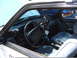 1987 Ford Mustang - Interior view of a 1987 Ford Mustang police car, showing the dashboard and seats.