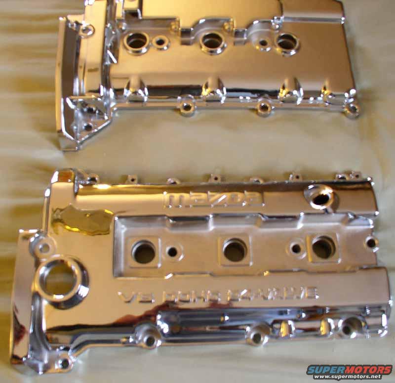 two chrome engine valve covers, one with 'mazda' visible