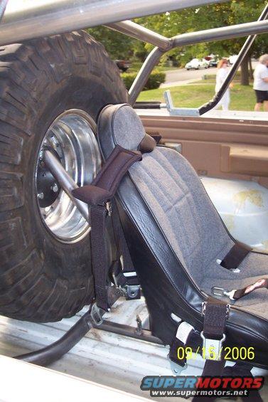Interior roll cage with spare tire and racing seat