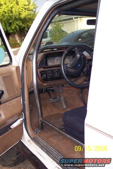 Interior of a truck showing the dashboard, steering wheel, and a roll cage. A date stamp reads 09/15/2006