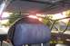 1989 Ford Bronco - The interior of a vehicle is shown with a prominent roll cage and a spare tire visible.