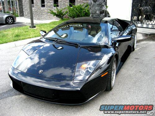 Black Lamborghini Murcielago parked on pavement, front 3/4 view