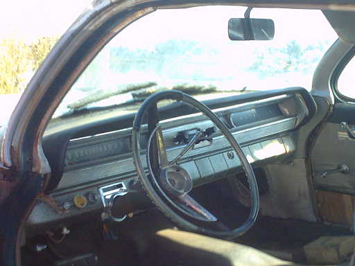1962 Pontiac Starchief interior showing dashboard, steering wheel, and door panel