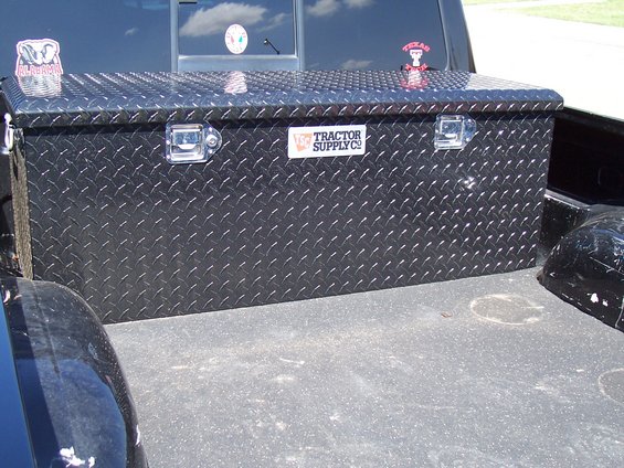Black diamond plate toolbox in truck bed with Tractor Supply Co. label