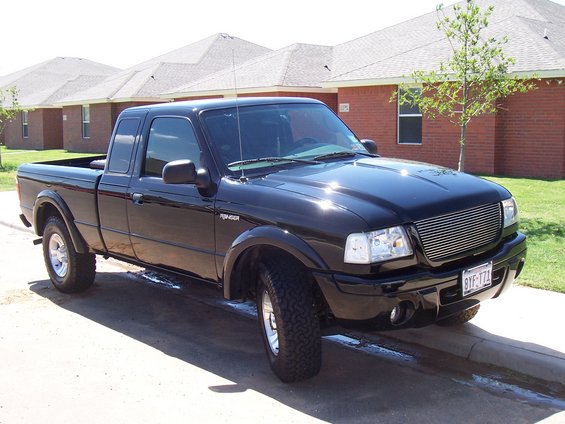Black 2003 Ford Ranger pickup truck parked on a residential street