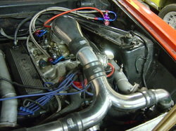 Modified V8 engine bay with aftermarket intake and wiring