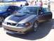 2002 Ford Mustang - A gray 2002 Ford Mustang is parked next to a blue Ford Mustang at an outdoor car show.