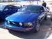 2002 Ford Mustang - A blue Ford Mustang is parked at an outdoor car show, with another Mustang visible behind it.