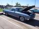 2002 Ford Mustang - A blue El Camino is parked with its hood open, showing the engine bay.