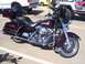2002 Ford Mustang - A maroon Harley-Davidson motorcycle is parked in a lot, with other vehicles visible in the background.