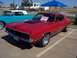2002 Ford Mustang - Classic red car with a 'For Sale' sign parked at a car show next to a blue classic car.