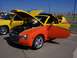 2002 Ford Mustang - A custom-painted Chevrolet SSR is displayed at a car show with its hood and door open.