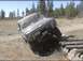 1985 Ford Bronco - This SUV is attempting to cross a series of logs in an outdoor setting.