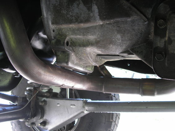 Underside view of a vehicle's exhaust system and suspension components