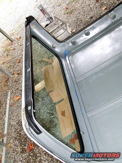 Interior of vehicle roof and window frame with cardboard covering