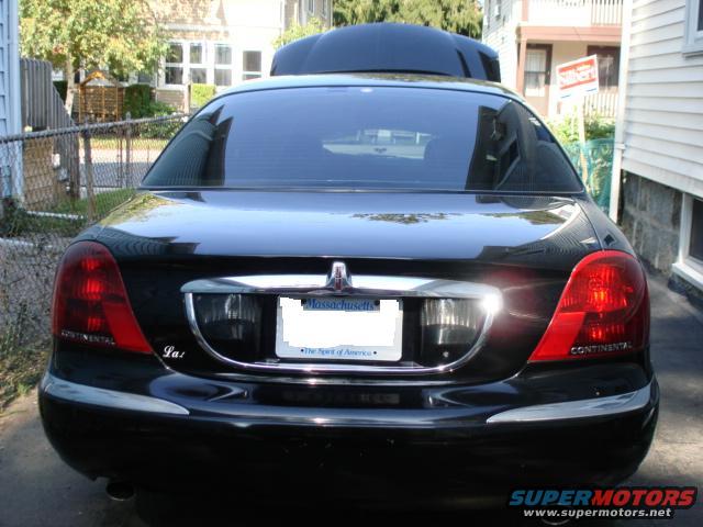 Black Lincoln Continental sedan, rear view, showing taillights and license plate