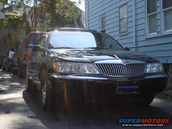 Black Lincoln Continental parked in driveway, other cars behind it