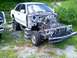 2002 Ford Crown Victoria - This 2002 Ford Crown Victoria is missing its front end and is propped up on cinder blocks.
