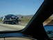 1992 Ford Taurus - A blue 1992 Ford Taurus is transported on a tow truck along a highway.
