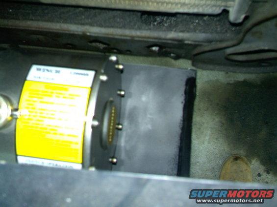 Winch unit with yellow label and visible connectors, mounted under a vehicle